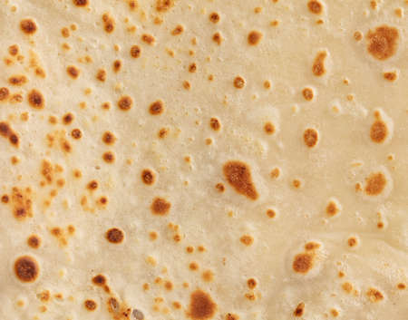 Pan fried pancake as a background. close-up