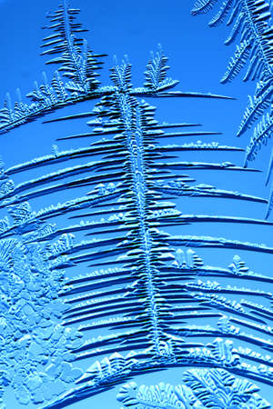 Gold patterns from frost on glass as a background. Close-upの写真素材