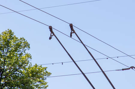 Trolley bus wires against the blue sky. background