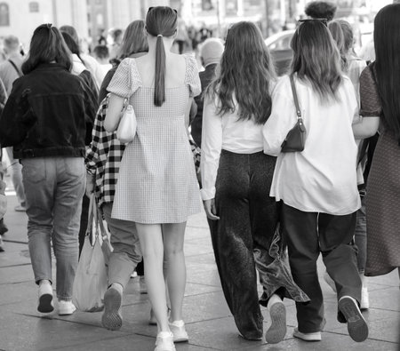 People walk down the street in the city during the day
