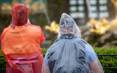 People in raincoats in the parkの写真素材