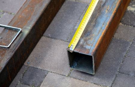 Measuring metal at a construction siteの写真素材