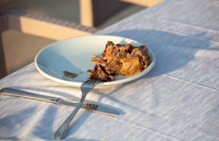 Grilled meat in a plate on a table in a restaurant.