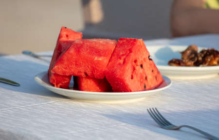 Red watermelon in a plate on a table in a restaurant.