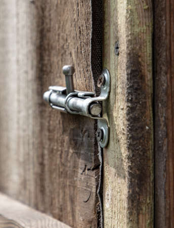 A latch on an old wooden door. close-upの写真素材