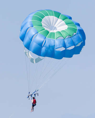 The parachute is flying in the blue sky.の写真素材