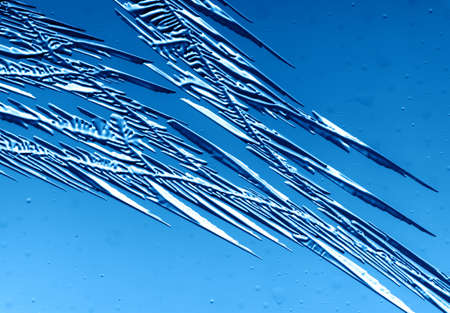 Gold patterns from frost on glass as a background. Close-up