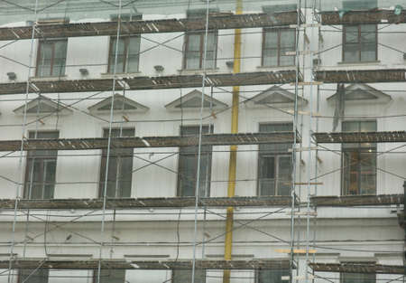Scaffolding near the wall of a multi-storey building. reconstruction