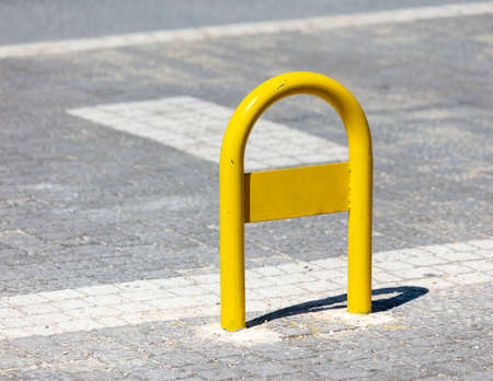 Yellow metal parking limiter. vehicle parkingの写真素材
