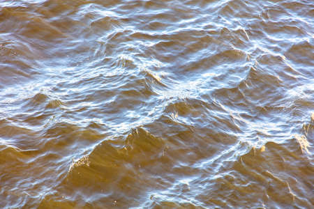 Wavy surface of water in a reservoir as an abstract background.