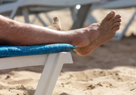 Feet of a man on the seashore.の写真素材
