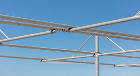 Metal frame against the blue sky.