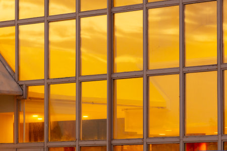 The windows of the house are in the rays of the golden sunset. background