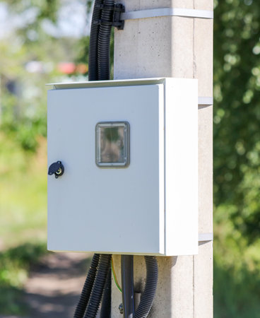 Electrical panel on a pole near the houseの写真素材