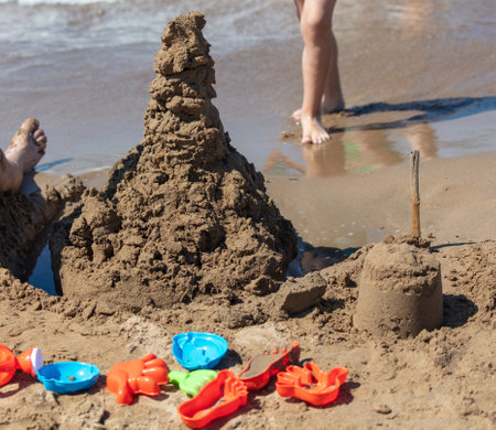 Children make sand houses on the beach.の写真素材