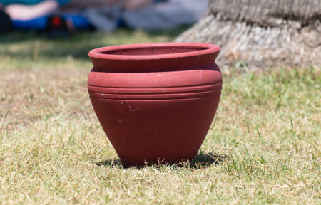 Clay jug for garbage in the park.