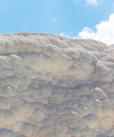 A mountain of white volcanic limestone rock against a blue sky. Natureの写真素材