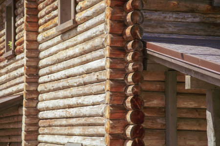 Wooden logs on the wall from the log house. backgroundの写真素材
