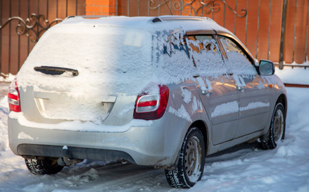 Car covered in snow in winterの写真素材
