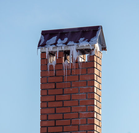 Ventilation pipe on the roof of a house with snow. Winterの写真素材