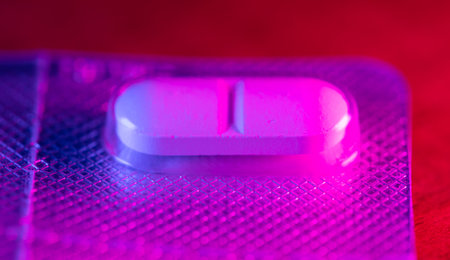 Pills on the table in blue-pink color. close-up