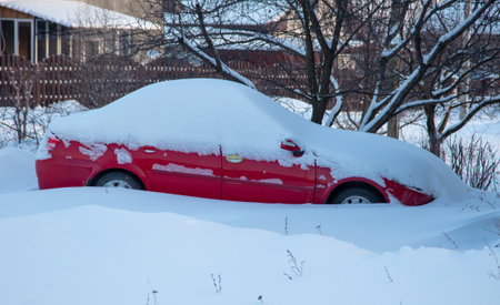 Car covered in snow in winterの写真素材