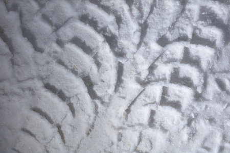 Traces from a car in winter as a background. close-up