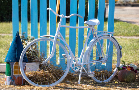 White bicycle near the blue wooden fence.の写真素材