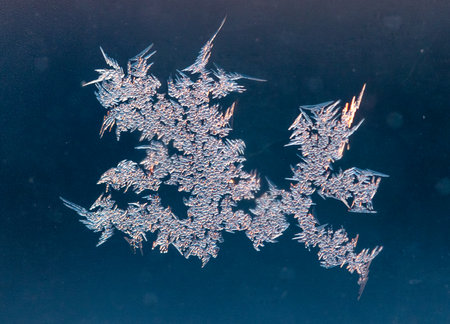 Frozen water on glass at sunrise. close-up.