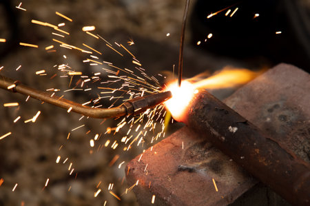 The welder welds a metal pipe. technologyの写真素材