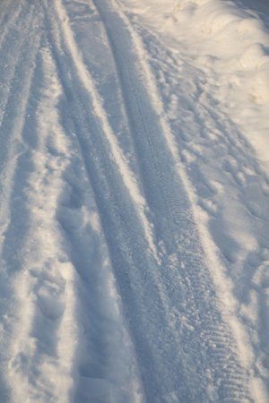 Traces of a car in the snow as a background. Winterの写真素材