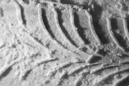 Traces from a car in winter as a background. close-upの写真素材