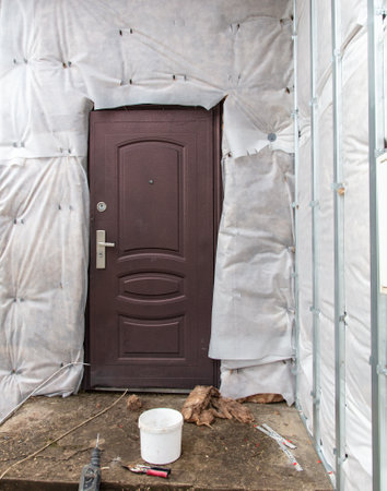 Door in the wall of the oma at the construction site.の写真素材