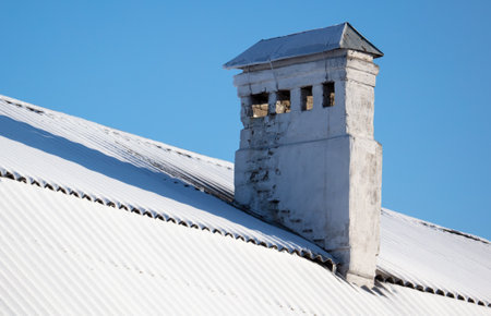 Ventilation pipe on the roof of a house with snow. Winterの写真素材