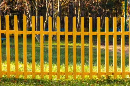 Wooden fence painted with yellow paint. backgroundの写真素材