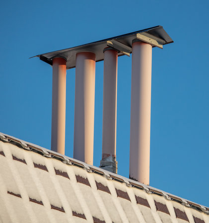Ventilation pipe on the roof of a house with snow. Winterの写真素材