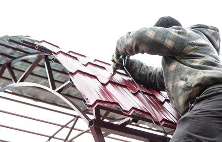 The worker sets the metal sheets on the weight. Technologyの写真素材