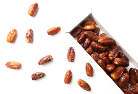 Dried dates in a box isolated on a white background. close-up