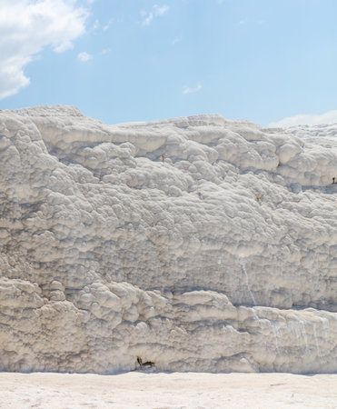 A mountain of white volcanic limestone rock against a blue sky. Natureの写真素材
