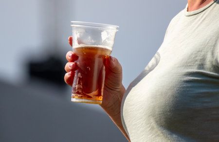 Woman with a mug of beer in natureの写真素材