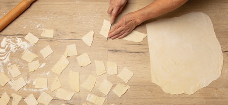 Cutting dough with a knife. cooking food