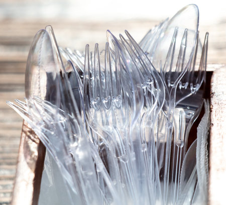 Plastic forks and spoons on the table. close-upの写真素材