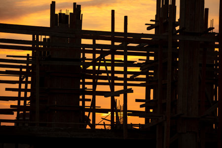Silhouette of a house under construction on the background of the sunset.の写真素材