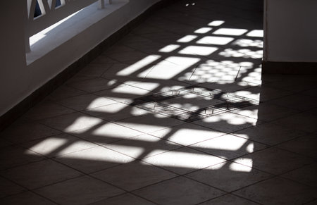 Shadow from the window on the floor in the room. backgroundの写真素材