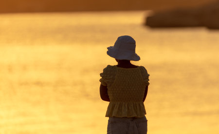Silhouette of a girl on the seashore. Nature