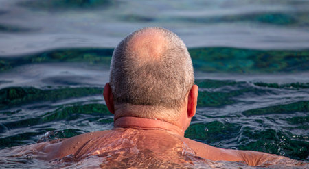 Man swims in the water of the seaの写真素材