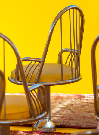 Yellow chairs with metal backs.の写真素材