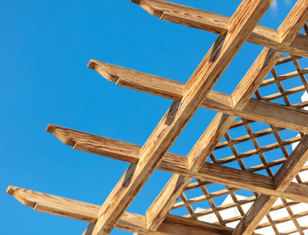 Wooden roof made of boards on a house against a blue sky.の写真素材