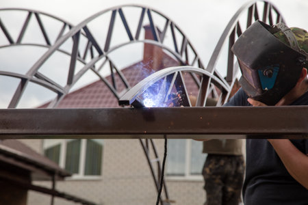 The worker installs the metal on the canopy. construction