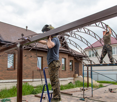 The worker installs the metal on the canopy. constructionの写真素材